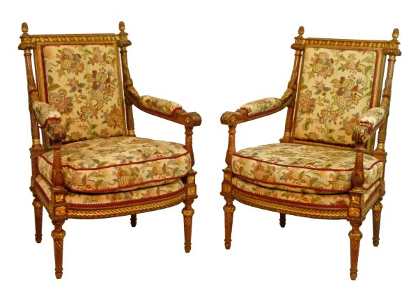 Pair of French carved walnut and giltwood open arm elbow chairs, each upholstered in floral