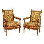 Pair of French carved walnut and giltwood open arm elbow chairs, each upholstered in floral