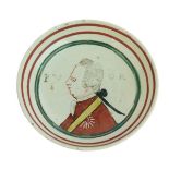 18th Century Dutch creamware pin dish decorated with a regal figure and the script 'PVOR', 10.25cm