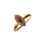 18ct gold dress ring set three ruby coloured stones with a diamond surround in a marquise setting