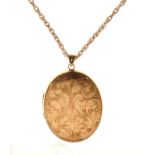 9ct gold oval locket having engraved scrolling decoration, with chain stamped 9ct Condition:
