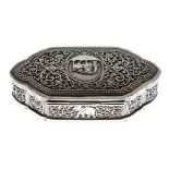 Ceylon white metal oval box having a hinged cover, allover decoration depicting animals amongst