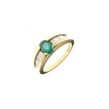 Dress ring set oval emerald coloured stone flanked by graduated baguette diamond shoulders, the