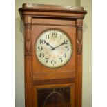 Early 20th Century oak longcase clock having silvered dial with Arabic numerals, the door having