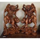 Pair of Chinese carved wooden figure groups, each depicting a figure seated on a tiger Condition: