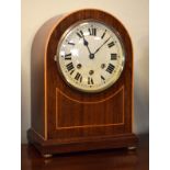 Early 20th Century string inlaid mahogany arch cased mantel clock, the silvered dial with Roman