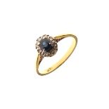 Dress ring set central sapphire coloured stone with a diamond surround, the shank stamped 18ct, size