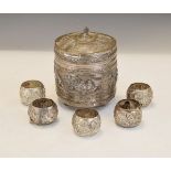 Indian white metal circular box and cover decorate with figures in a landscape together with five