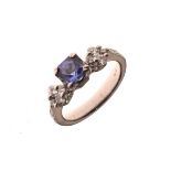 White metal dress ring set central tanzanite with diamond shoulders, the shank stamped PT 900,
