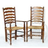Pair of early 20th Century beech ladder back open arm elbow chairs, each having a rush seat and
