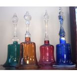 Four glass bells, each having a coloured bowl Condition: