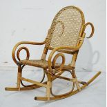 Child's bamboo framed rocking chair having a split cane seat and back Condition: