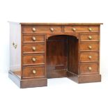19th Century mahogany kneehole pedestal desk having an inset leather writing surface, fitted ten