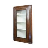 Oak hanging corner cabinet fitted four shelves enclosed by a glazed door Condition: