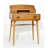 Ercol light elm and beech writing table, the raised back fitted an one shelf and two short