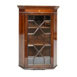 Edwardian inlaid mahogany hanging corner cabinet fitted three shelves enclosed by an astragal glazed