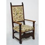 20th Century carved oak high back open arm elbow chair, the seat and back upholstered in simulated