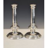 Pair of Elizabeth II silver candlesticks, each having a plain tapered cylindrical column and