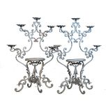 Pair of wrought and cast metal plantstands, each having five branches, central oval platform and