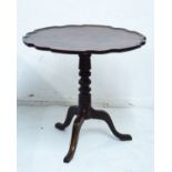Mahogany circular snap top supper table having a pie crust edge and standing on a turned pillar