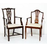 Two reproduction mahogany finish open arm elbow chairs, each having a drop-in seat and standing on