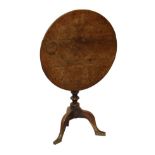 Victorian oak and walnut circular snap top supper table standing on a turned pillar and tripod