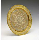 Late 19th/early 20th Century Indian embossed white metal and brass circular wall plaque decorated