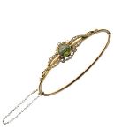 Unmarked yellow metal snap bangle set seed pearls and green stone, 7.6g gross approx Condition: