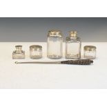 Five Victorian glass dressing table jars, each having an engraved silver cover hallmarked for London