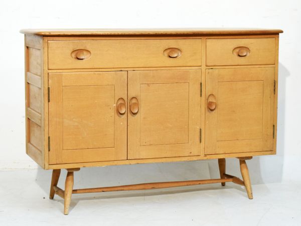 Ercol light elm and beech sideboard fitted one long and one short drawer with three cupboard doors