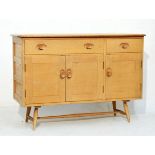 Ercol light elm and beech sideboard fitted one long and one short drawer with three cupboard doors