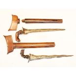 Two Malaysian/Indonesian Kris, the first with wavy pamor blade, wooden hilt of Garoda form in its