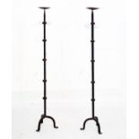 Pair of wrought iron floor standing pricket candlesticks Condition: