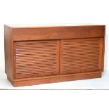 1960's period teak sideboard fitted two short drawers above a pair of sliding louvre doors