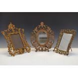 Two early 20th Century cast metal picture frames together with a brass easel picture frame