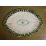 Oval pottery dish having moulded basket weave decoration and a pierced border Condition: