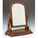 Victorian mahogany dressing table mirror having scroll supports and standing on a platform base