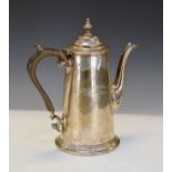 George V silver coffee pot of tapered cylindrical form, the spout with embossed decoration,