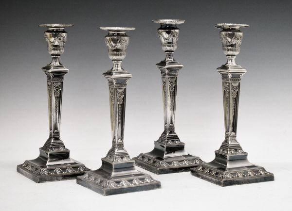 Set of four 19th Century Adam style silver plated candlesticks, each having ribbon and swag