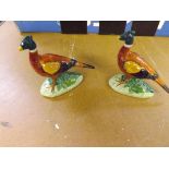 A pair of small Beswick cock pheasants with Beswick labels attached.