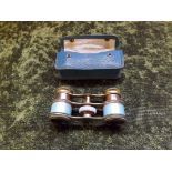 A pair of ladies French style opera glasses with blue enamel mounts, in original leather carrying