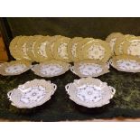 A 19th century continental porcelain dessert set comprising 4 oval pedestal plates, 2 circular