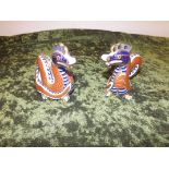 A pair of royal Crown Derby figurines depicting Dragons being LIV.