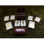 A leather case with compartments containing 4 honours and trick pads, 2 packs of John Waddington