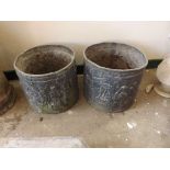 A pair of unusual cylindrical lead planter with embossed classical decoration and pierced base,