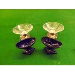 A pair of early 19th century Coalport blue glass oval salt cellars on triangular lemon squeezer