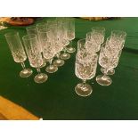 A part suite of 20th century pedestal glasses comprising 10 champagne flutes and 7 pedestal wine