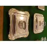 Two silver-plated entree dishes and covers with gadrooned border, one with decorated corners.