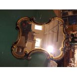 An early 19th century ebony and ormolu Rococo style dressing table/hanging mirror 25" x 19".