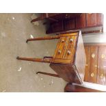 A small antique mahogany drop flap work table with 2 drawers having turned and tapering legs.